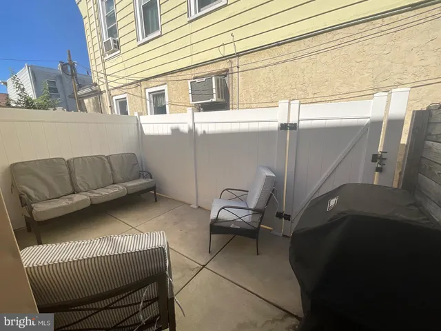 a view of two chairs in the balcony