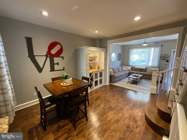 a living room with furniture a large window and work place