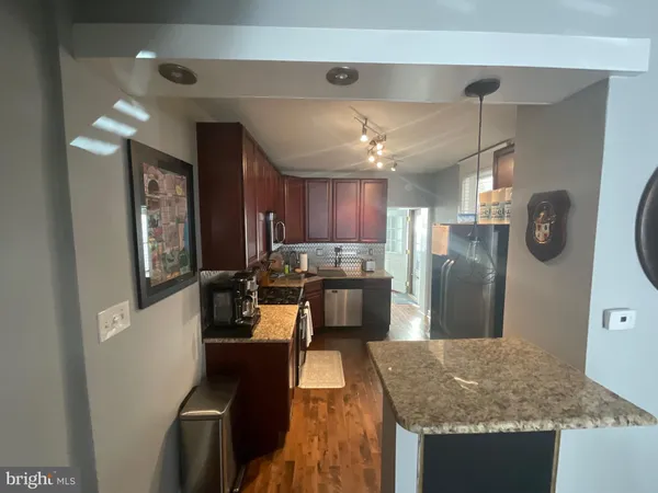 a kitchen with refrigerator and window