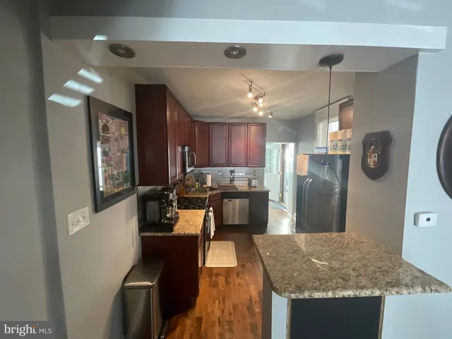 a kitchen with refrigerator and window