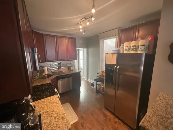 a kitchen with stainless steel appliances refrigerator stove microwave and cabinets