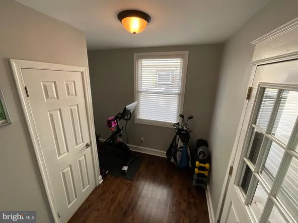 a view of a room with wooden floor and windows