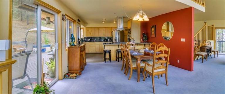 8707 Yank Gulch Road Talent, OR 97540 - Photo 7 of 19 a dining room with furniture a chandelier and wooden floor