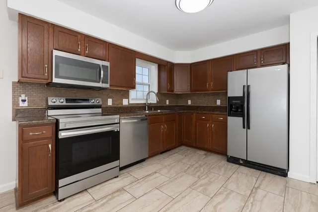 a kitchen with a sink stove and microwave