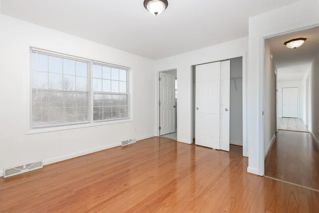 a bathroom with a toilet sink vanity and mirror