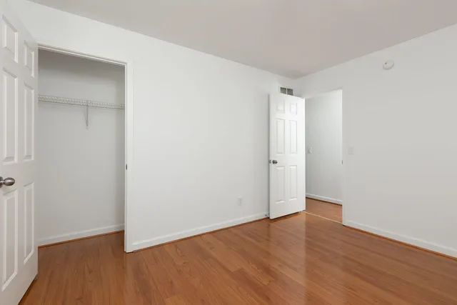 a kitchen with kitchen island granite countertop a stove and a refrigerator