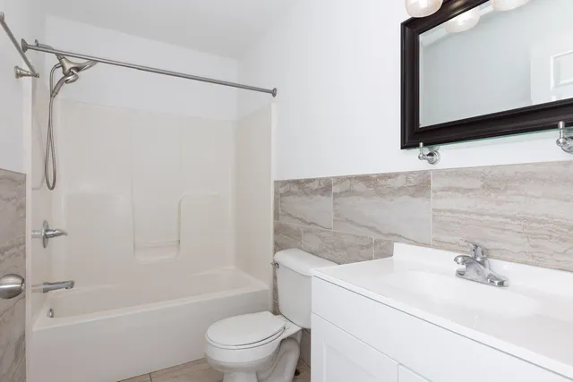 a view of kitchen with sink and refrigerator