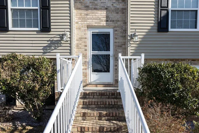 a view of a balcony with wooden floor and fence and a window