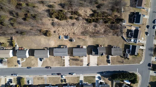 an aerial view of residential houses with outdoor space