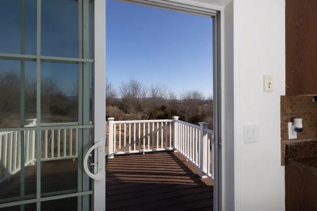 a view of a balcony with wooden floor