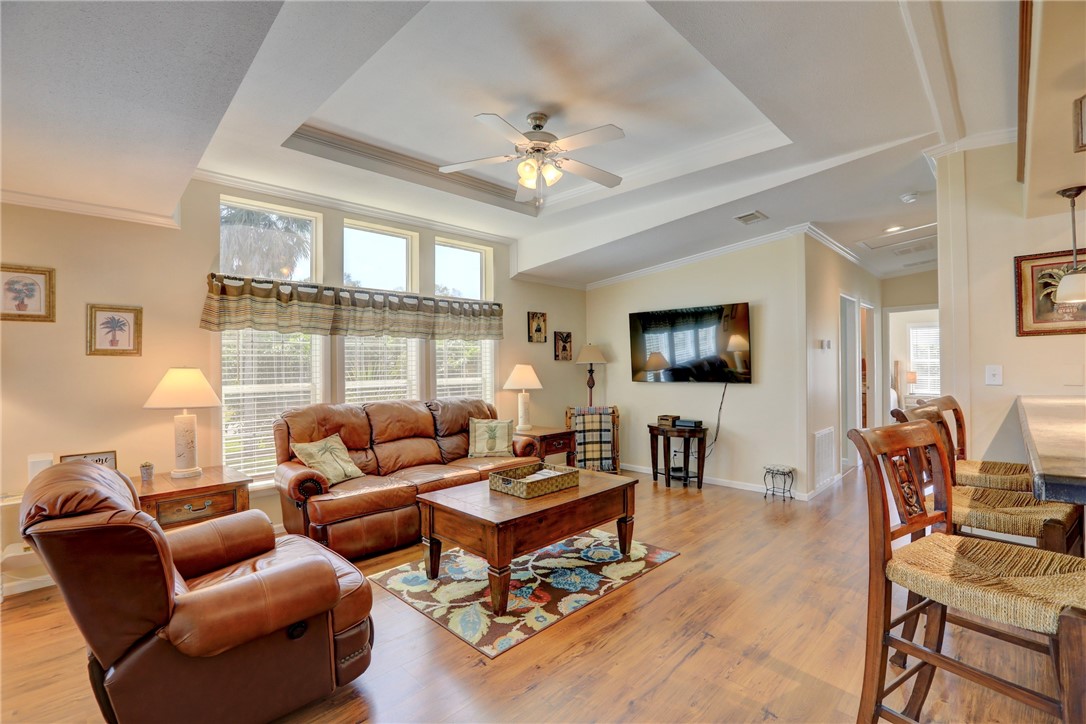 309 Pineapple Street Sebastian, FL 32958 - Photo 13 of 36 a living room with furniture a flat screen tv and a large window
