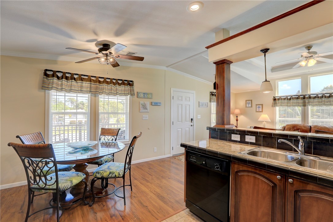309 Pineapple Street Sebastian, FL 32958 - Photo 17 of 36 a kitchen with a table chairs stove and sink