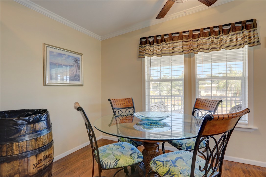 309 Pineapple Street Sebastian, FL 32958 - Photo 19 of 36 a view of a dining room with furniture and wooden floor