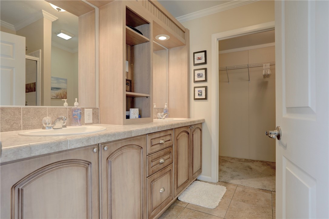 309 Pineapple Street Sebastian, FL 32958 - Photo 29 of 36 a spacious bathroom with a granite countertop sink and a mirror