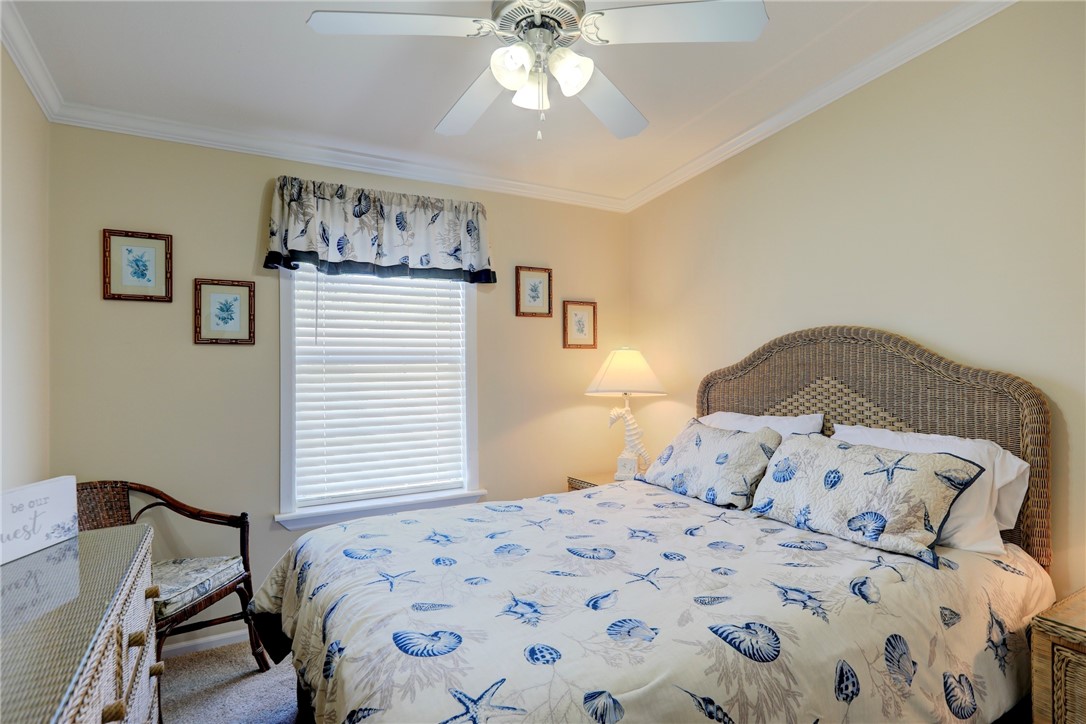 309 Pineapple Street Sebastian, FL 32958 - Photo 31 of 36 a bedroom with a bed and a chandelier
