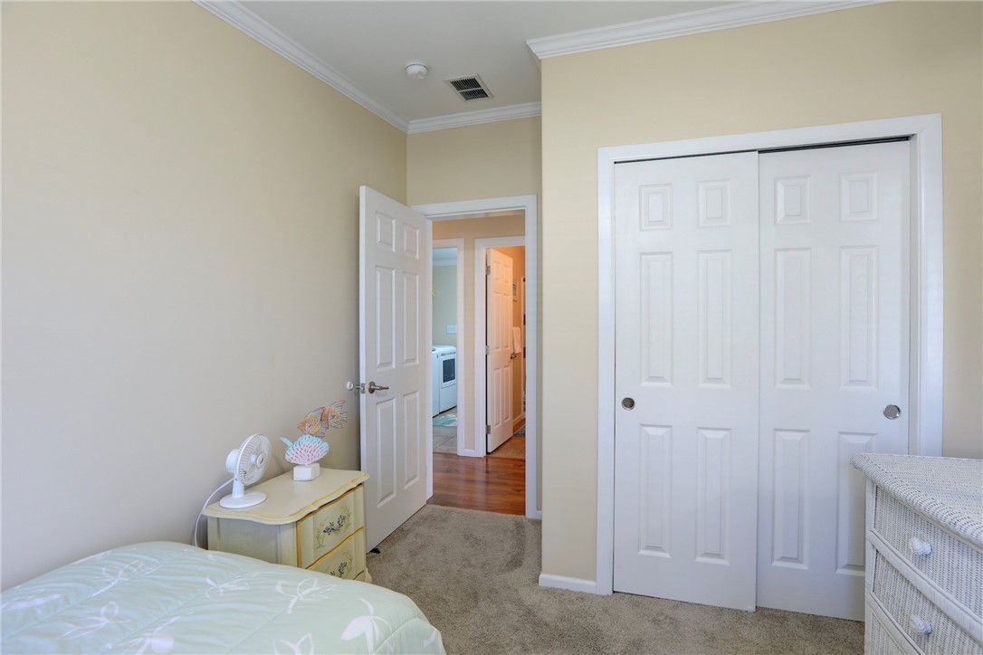 309 Pineapple Street Sebastian, FL 32958 - Photo 34 of 36 a bedroom with a bed and a table