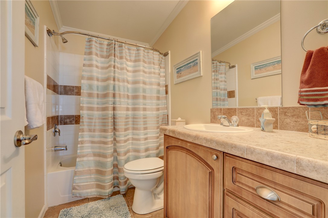 309 Pineapple Street Sebastian, FL 32958 - Photo 35 of 36 a bathroom with a granite countertop sink toilet and shower