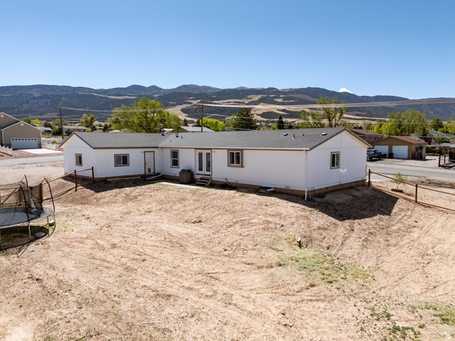 1637 East Midvalley Road Enoch, UT 84721 - Photo 46 of 48 White exterior with a dark shingle roof and multiple windows