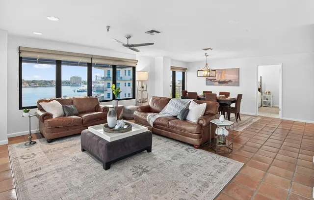 a living room with furniture a rug and a chandelier