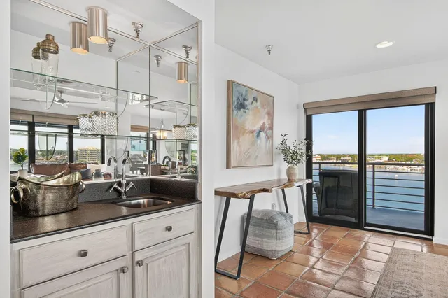 a view of a dining room with furniture a chandelier and wooden floor