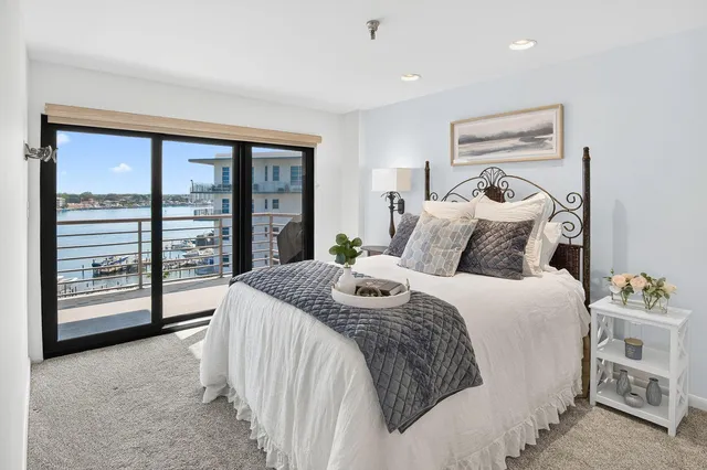 a bedroom with a bed and a large window