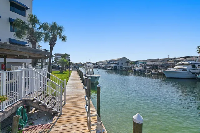 a view of a lake with houses in back