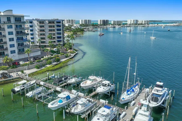 a living room with furniture large windows and a rug