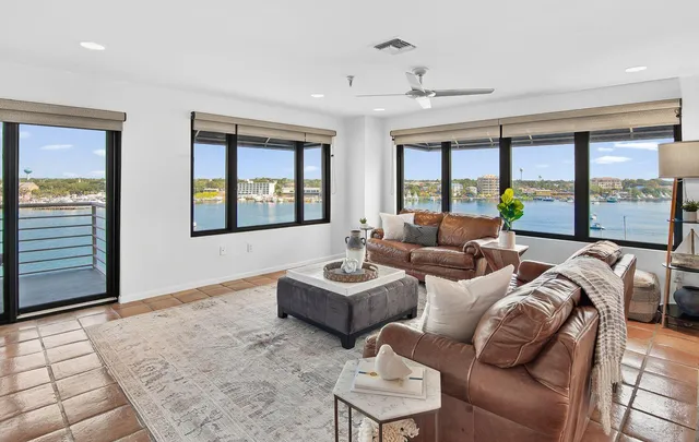 a living room with furniture fireplace and a large window