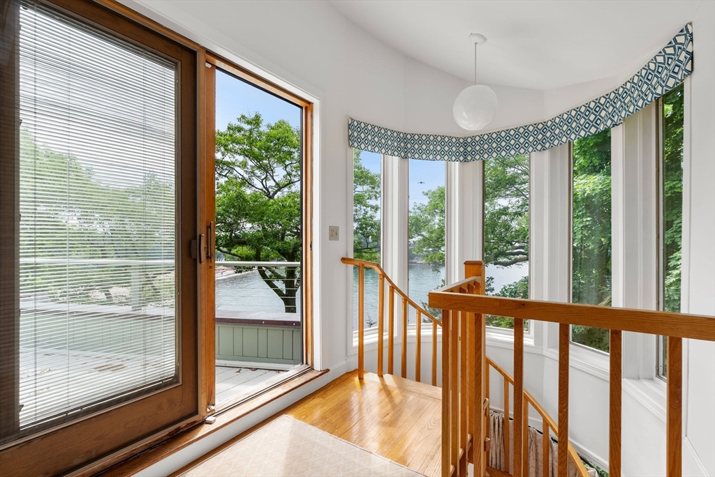 23 Ocean Street Manchester, MA 01944 - Photo 21 of 36 a view of a room with wooden floor and windows