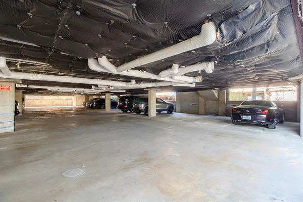 a view of parking garage with cars