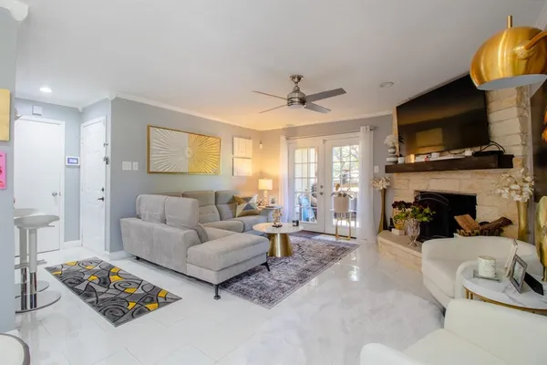 a living room with furniture a fireplace and a flat screen tv