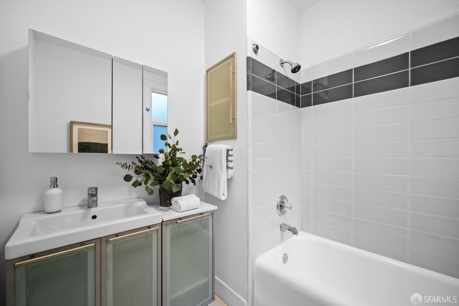 1310 5th Avenue, Unit 1 San Francisco, CA 94122 - Photo 17 of 31 a bathroom with a tub sink and mirror