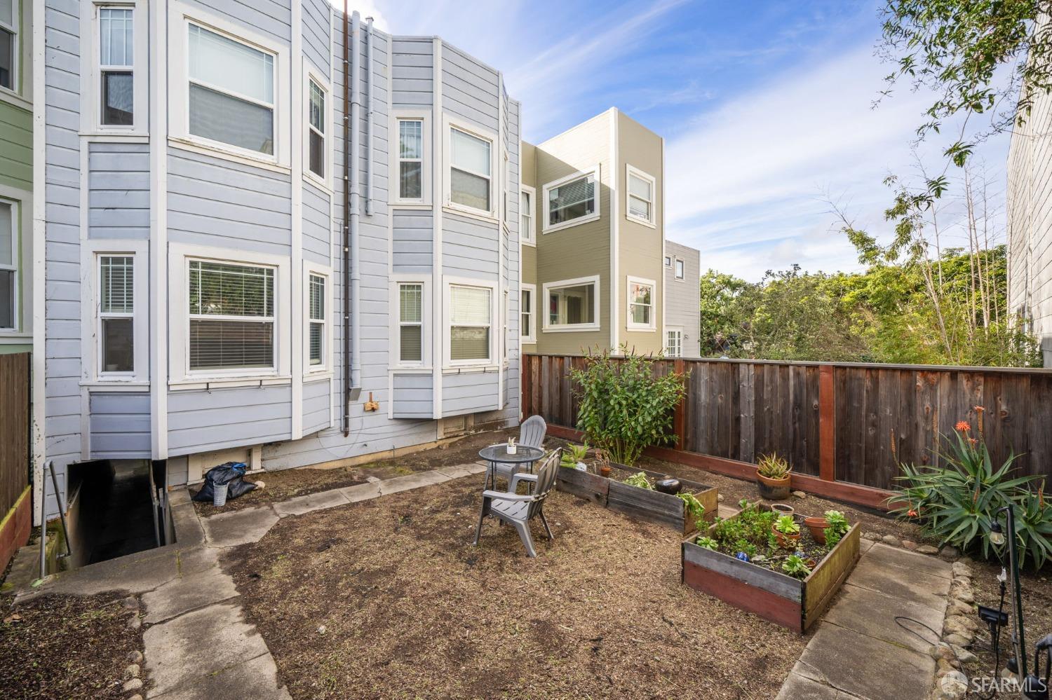 1310 5th Avenue, Unit 1 San Francisco, CA 94122 - Photo 22 of 31 a backyard of a house with potted plants and a bench