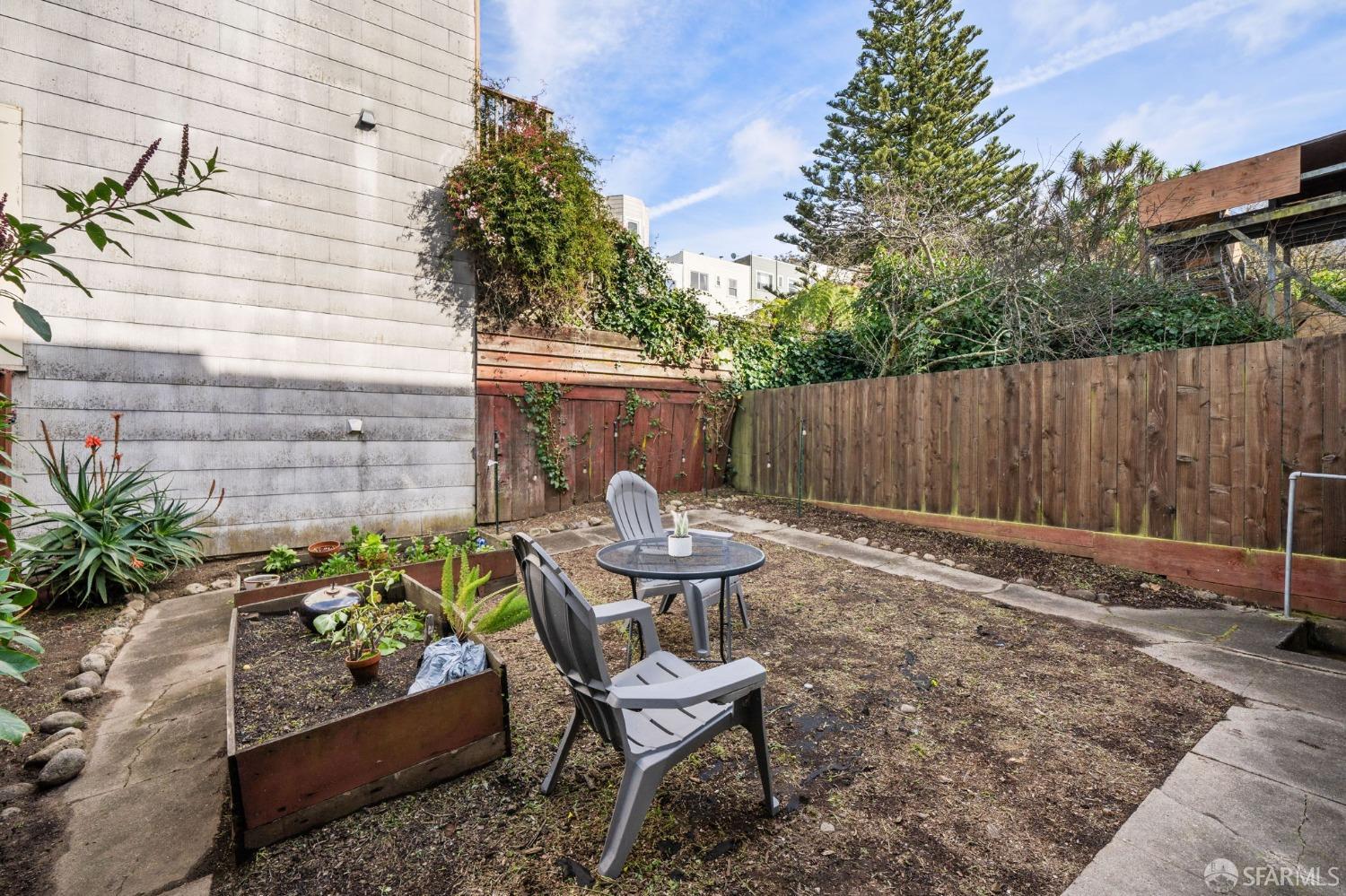 1310 5th Avenue, Unit 1 San Francisco, CA 94122 - Photo 25 of 31 a view of a backyard with chairs and a potted plant