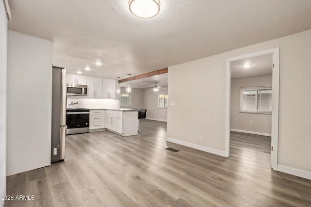 a view of a kitchen with a sink and a refrigerator