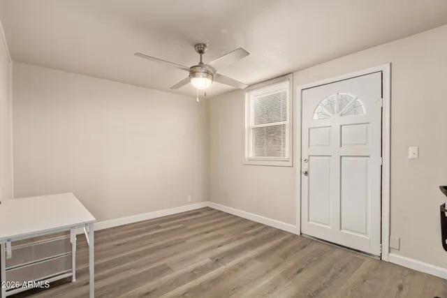 wooden floor in an empty room with a window