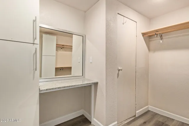 a view of a small space with wooden floor and a window