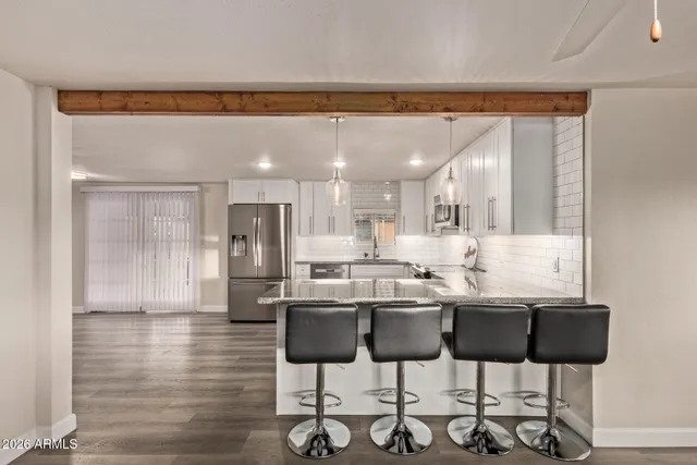 a kitchen with a dining table and chairs