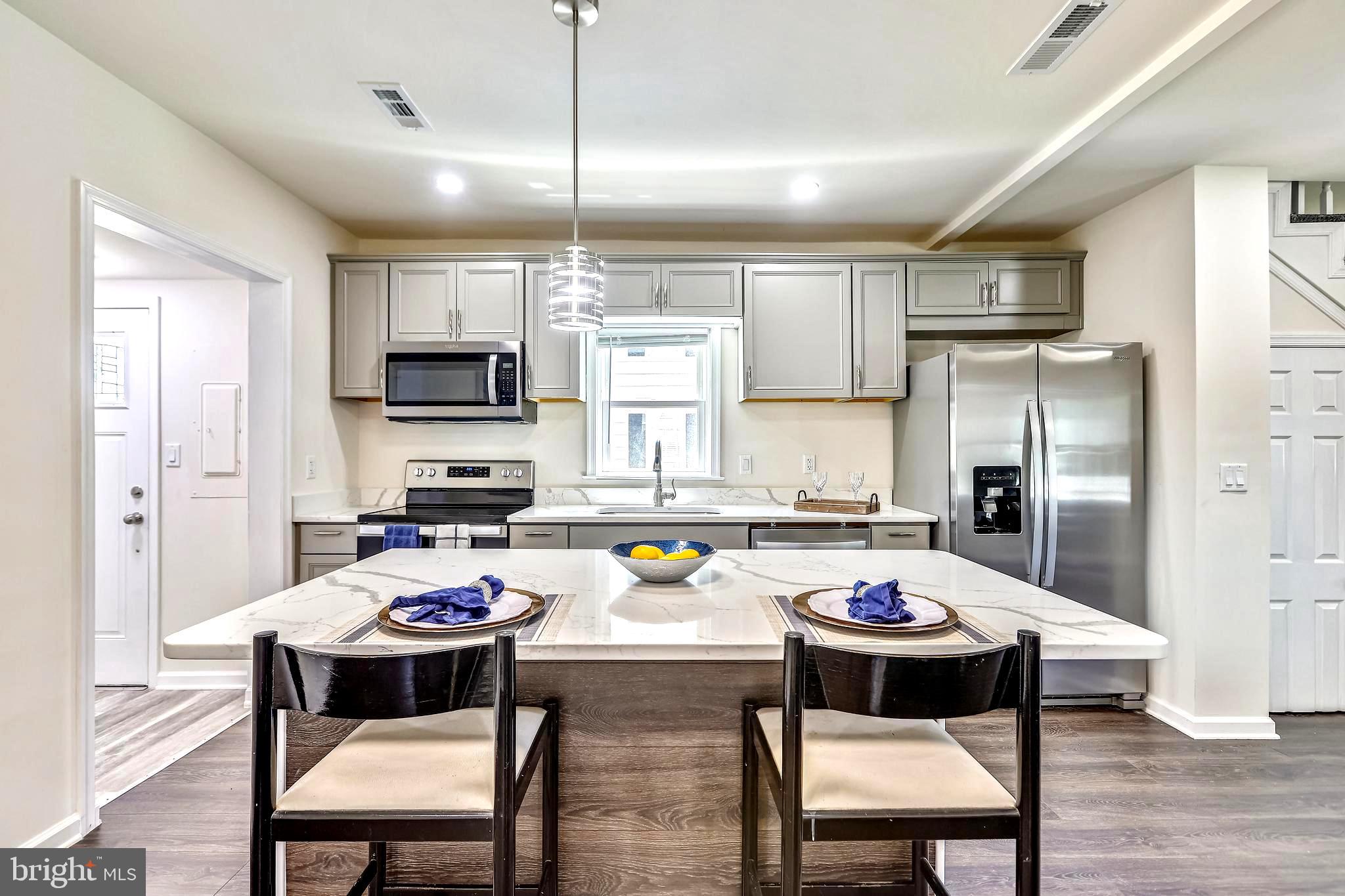 208 Maple Avenue Ridgely, MD 21660 - Photo 15 of 38 Sleek Quartz Counters . Island Dining Bar