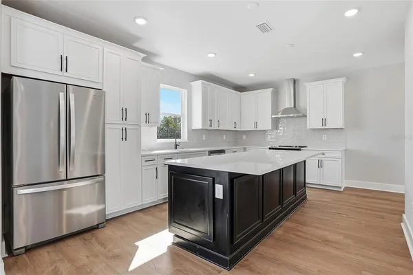 a kitchen with a stove sink and refrigerator