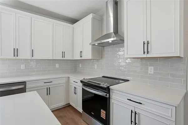 a kitchen with white cabinets and white appliances