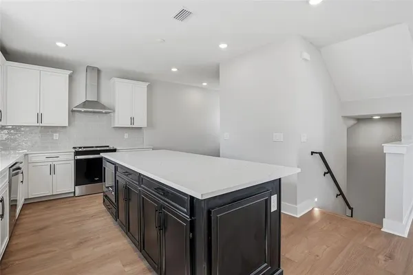 a kitchen with a stove sink and a refrigerator