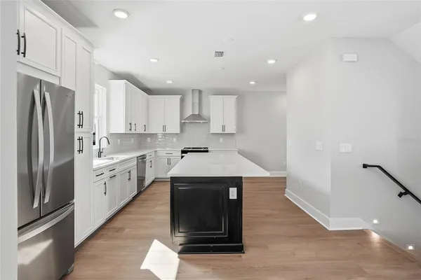 a kitchen with a sink stainless steel appliances and cabinets