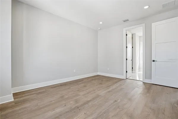 a view of an empty room with wooden floor