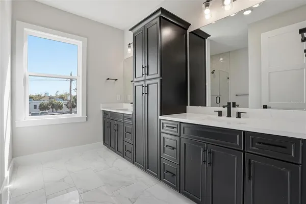 a bathroom with a double vanity sink and a mirror
