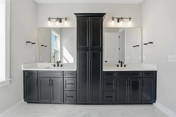 a bathroom with a double vanity sink and mirror