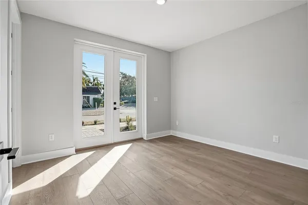 a view of a livingroom with wooden floor and a window