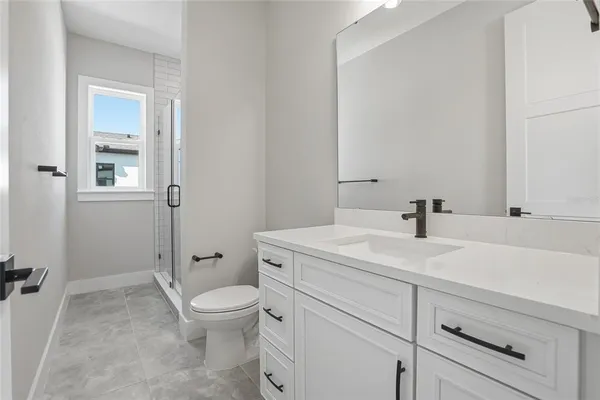 a bathroom with a sin toilet sink vanity and mirror