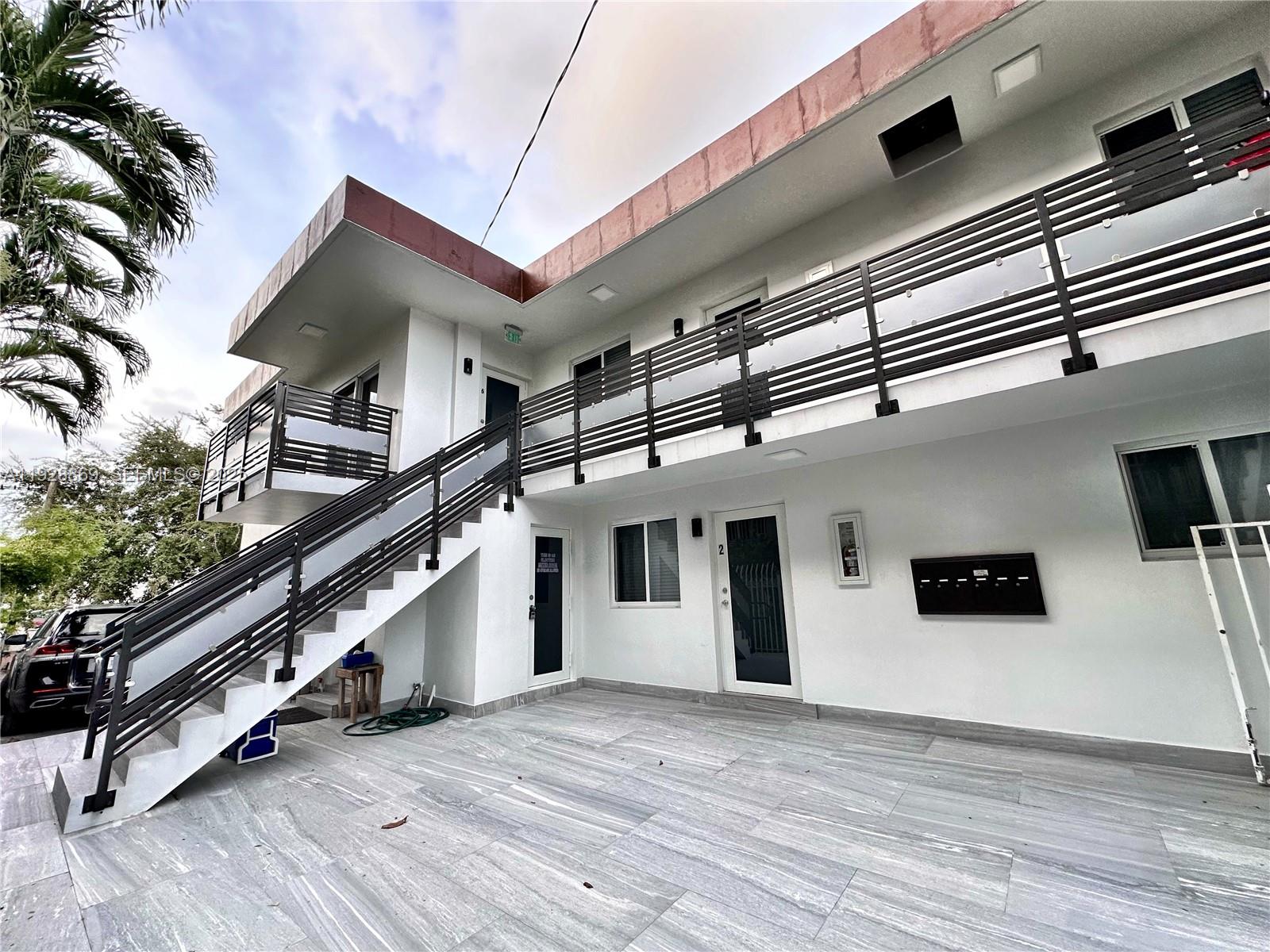 1629 Southwest 3rd Street, Unit 5 Miami, FL 33135 - Photo 4 of 24 a big room with wooden floor and fence