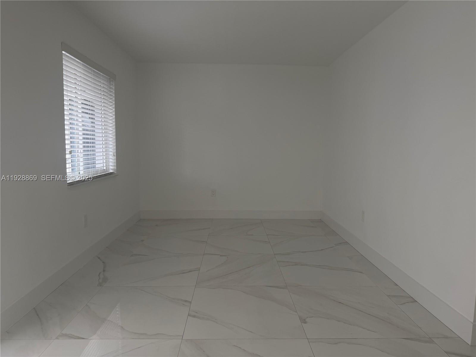 1629 Southwest 3rd Street, Unit 5 Miami, FL 33135 - Photo 8 of 24 a room that has a window in it